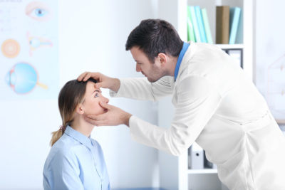 A doctor checking someone's eyes